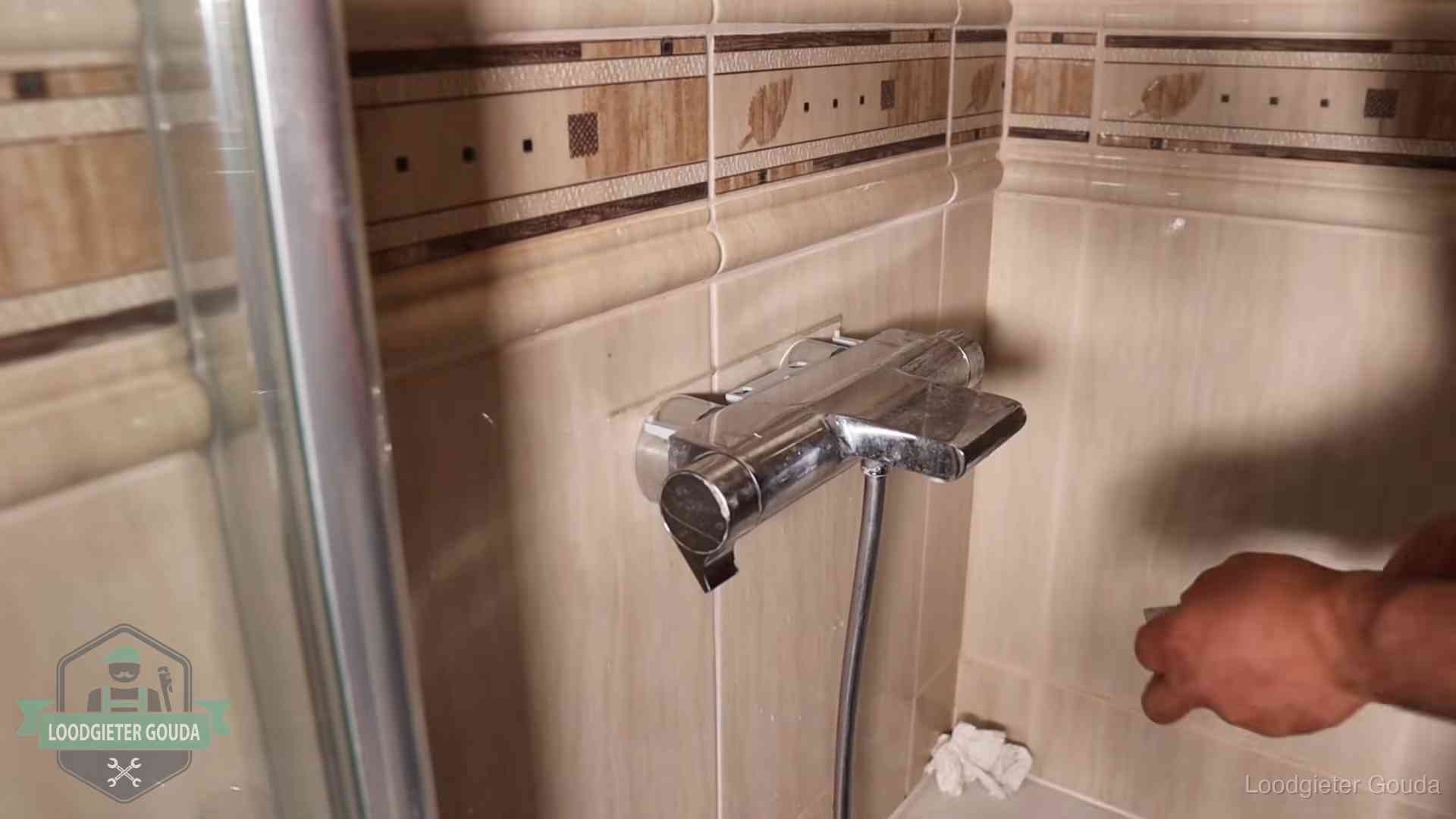 Verkalkte douche-mengkraan in Gouda, hetzelfde kalk dat zich in de warmtewisselaar afzet